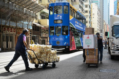 Workers push trolleys of goods on a street in Hong Kong, China, on April 15, 2025.
