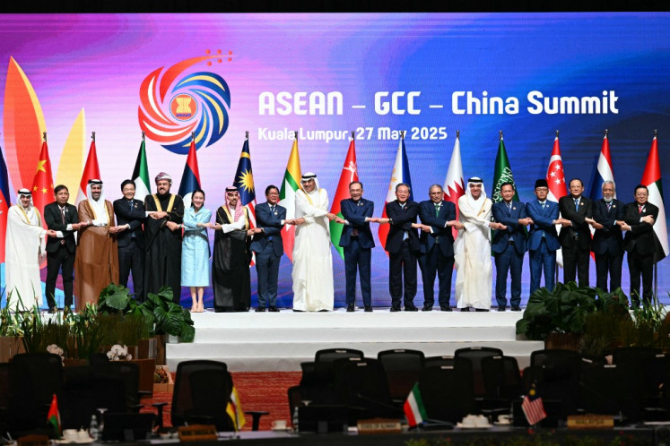(Left-right) Secretary General of the Gulf Cooperation Council (GCC) Jasem Albudaiwi, Myanmar's Permanent Secretary of the Ministry of Foreign Affairs Aung Kyaw Moe, Qatar's Minister of Commerce and Industry Faisal bin Thani bin Faisal Al Thani, Singapore's Prime Minister Lawrence Wong, Oman's Deputy Prime Minister for Relations and International Affairs Sayyid Asaad Tariq Taimur Al Said, Thailand's Prime Minister Paetongtarn Shinawatra, Saudi Arabia's Foreign Minister Prince Faisal bin Farhan al-Saud, Philippines' President Ferdinand Marcos Jr, Crown Prince of Kuwait Sheikh Sabah Khaled al-Hamad al-Sabah, Malaysia's Prime Minister Anwar Ibrahim, China's Premier Li Qiang, Brunei Minister of Foreign Affairs Erywan Yusof, Ruler of the UAE's Emirate of Ras al-Khaimah Sheikh Saud bin Saqr al Qasimi, Cambodia's Prime Minister Hun Manet, Indonesia's Minister for Foreign Affairs Sugiono, Laos' Prime Minister Sonexay Siphandone, East Timor's Prime Minister Xanana Gusmao, and ASEAN Secretary-General Kao Kim Hourn pose for a group photo at the ASEAN - Gulf Cooperation Council (GCC) - China Summit after the 46th Association of Southeast Asian Nations (ASEAN) Summit in Kuala Lumpur on May 27, 2025. 