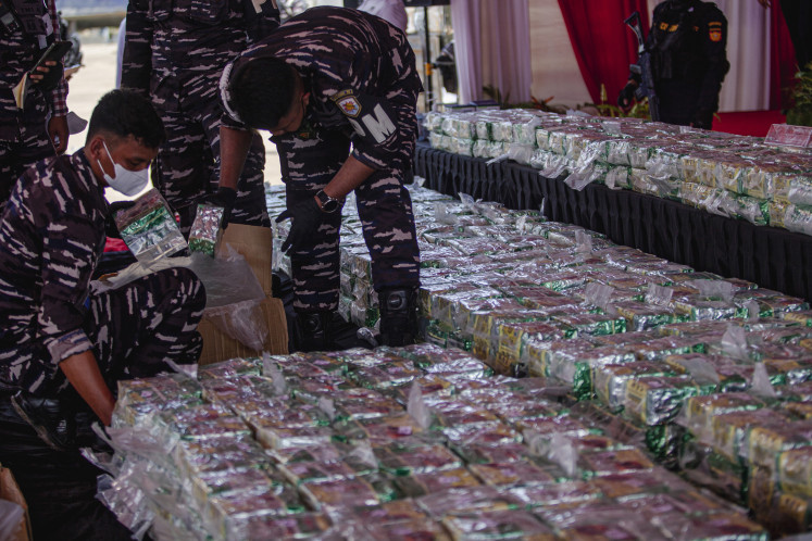 Indonesian Navy personnel inspect packages of methamphetamine at Batam Customs Port, Riau Islands, on May 26. A joint task force from the National Narcotics Agency (BNN), the National Police and the Indonesian Military seized the illicit drugs aboard the vessel Sea Dragon Tarawa in the waters off the Riau Islands on May 21, marking the largest drug seizure in the nation’s history.