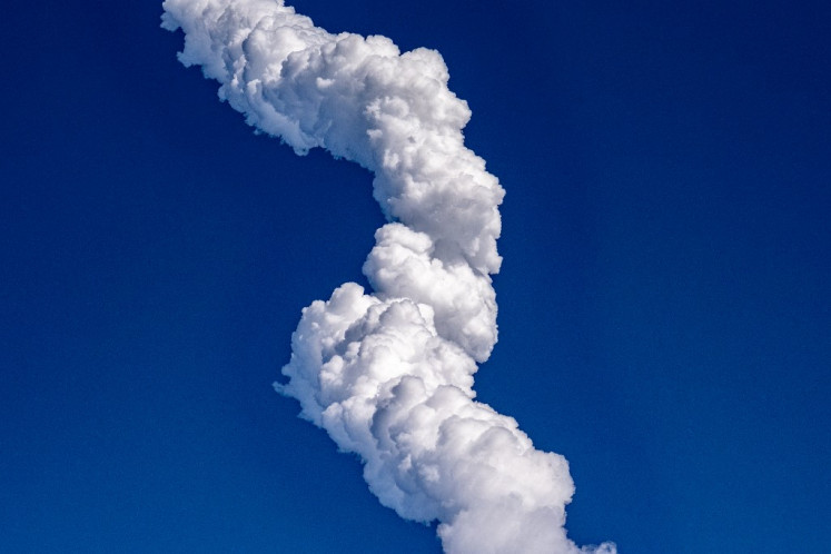 A plume of exhaust from the rocket boosters is left behind after the SpaceX Starship rocket launched from Starbase, Texas, as seen from South Padre Island on May 27, 2025. 