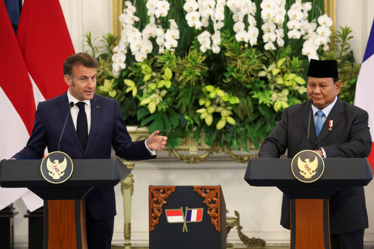 French President Emmanuel Macron (left) speaks during a press conference with President Prabowo Subianto at the Merdeka Palace in Jakarta on May 28, 2025.
