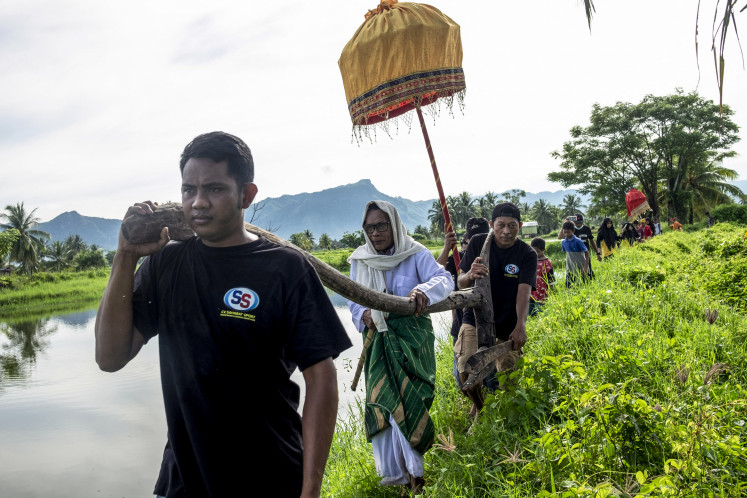 A ‘bissu’ (second left), a type of holy man or shaman in the Bugis culture, takes part in the Mappalili ceremony on Nov. 16, 2022, paying tribute to the rice goddess to mark the start of the harvest season in Pangkajene, South Sulawesi.