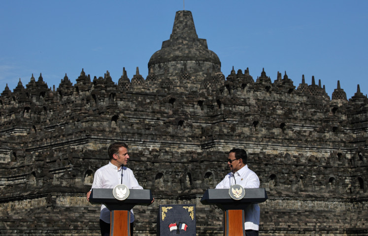 France's President Emmanuel Macron and Indonesian President Prabowo Subianto speak during a visit at Borobudur Temple, the world’s largest Buddhist monument and a UNESCO World Heritage Site, in Magelang, Central Java on May 29, 2025.