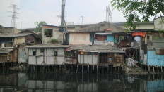 Densed neighborhoods is seen by a riverbank of Angke River in Pejagalan, Penjaringan North Jakarta on May 28, 2025. Insufficient spaces and improper sanitation facilities force some low-income families living in such slums across Jakarta to practice open defecation.