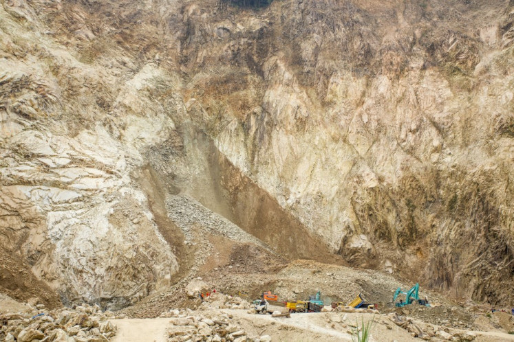 Rescuers use heavy equipment to search for landslide victims buried under rocks at the C excavation site in Cipanas, Dukupuntang, Cirebon Regency, West Java, on May 30, 2025. At least eight people were killed and a dozen injured on Friday in a rockfall at the limestone quarry, police said.