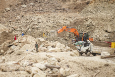 Rescuers use heavy equipment to search for landslide victims buried under rocks at a mine site in Cipanas, Dukupuntang, Cirebon regency, West Java, on May 30, 2025. 