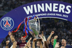 The UEFA Champions League trophy is lifted in the air as Paris Saint-Germain celebrate winning the UEFA Champions League final football match between Paris Saint-Germain (PSG) and Inter Milan in Munich, southern Germany, on May 31, 2025. 