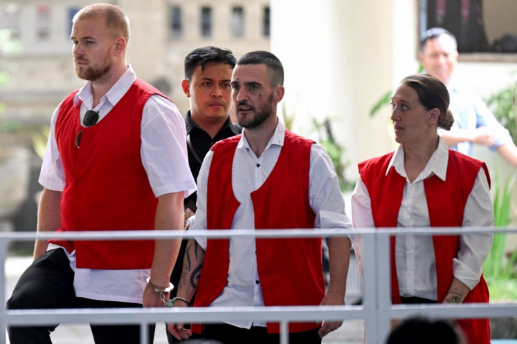 British nationals (left-right) Phineas Ambrose Float, Jonathan Christopher Collyer and Lisa Ellen Stocker are brought to court for their trial in Denpasar, Bali on June 3, 2025. 