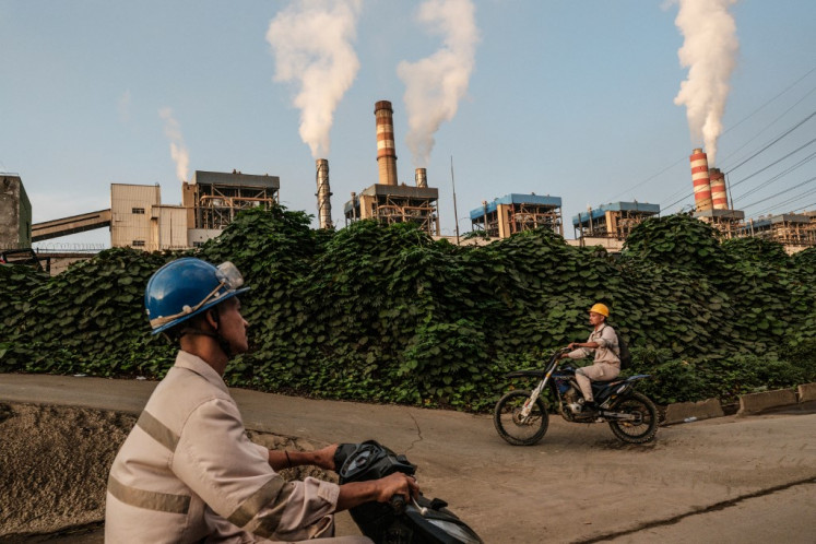 In this photo taken on April 18, 2025, workers ride motorbikes in the morning to enter Weda Bay Industrial Park (WBIP), a major nickel processing and smelting hub, in Lelilef Sawai, Central Halmahera, North Maluku. The home of the Hongana Manyawa indigenous tribe in central Halmahera was once a breathtaking kaleidoscope of nature that provided sanctuary and sustenance. But it is being eaten away by one of the world's largest nickel mining projects, as Indonesia exploits vast reserves of the metal used in everything from electric vehicles to stainless steel. 