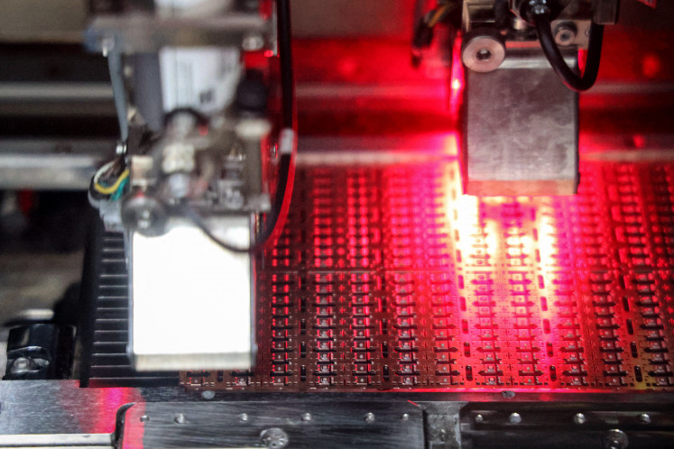 A machine produces semiconductor chips on Dec. 25, 2024, at a factory in Binzhou, Shandong, China.