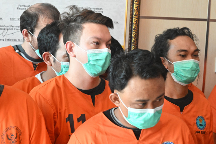 William Wallace Molyneaux (center left) of the US attends a press conference at the National Narcotics Agency Province of Bali, after being arrested on drug related crimes in Denpasar, on Indonesia resort island of Bali on June 5, 2025. Molyneaux was arrested on May 23, allegedly carrying seven packages containing 99 pills of amphetamine, Bali's narcotics agency told reporters in Denpasar. Molyneaux has multiple charges levelled against him including distributing drugs, which carries the maximum penalty of death by execution.