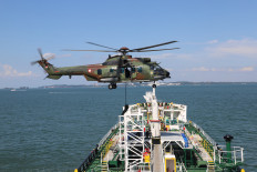 An Airbus H225 Caracal helicopter from the Indonesian Air Force's 8th squadron inserts special forces personnel onto a liquid natural gas carrier vessel during a joint exercise between the Singapore Armed Forces (SAF) and the Indonesian Military (TNI) in the waters around Batam, Riau Islands, on June 2-4, 2025. The Counter-Terrorism Field Training Exercise Griffin Cakti simulated the hijacking of an LNG tanker by terrorists to be detonated in the waters between Indonesia and Singapore.