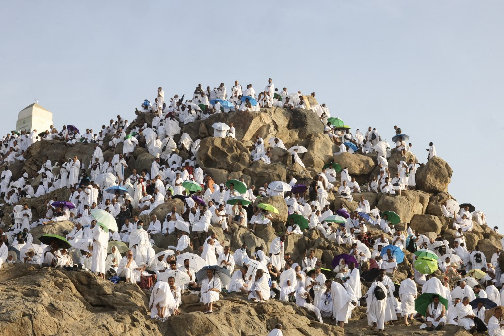 Muslim pilgrims pray at dawn on Saudi Arabia's Mount Arafat, also known as Jabal al-Rahma or Mount of Mercy, during the climax of the haj pilgrimage on June 5, 2025. Muslim pilgrims prayed atop Mount Arafat on June 5 during the high point of the annual haj pilgrimage, as Saudi officials called on participants to refrain from being outside during the hottest hours of the day. 