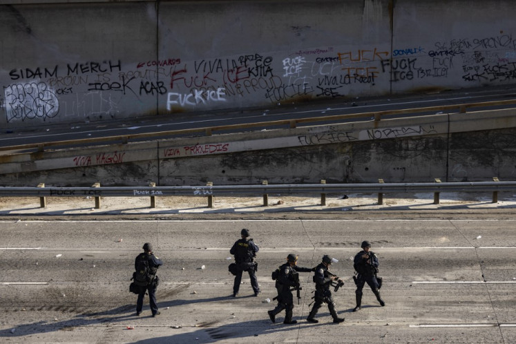 Law enforcement deploy on the 101 Freeway as clashes erupt with demonstrators in the streets around the federal building during a protest sparked by federal immigration operations in Los Angeles, California, on June 8, 2025. 