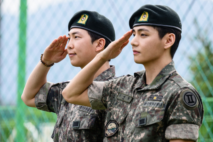 K-pop boy band BTS members RM (left) and V salute for fans and members of the press at an outdoor sporting facility in Chuncheon on June 10, 2025, after their release from 18 months of South Korean military service. Hundreds of fans gathered near two army bases just outside of the capital Seoul where band leader RM, recently named “Favorite K-pop Artist“ at the American Music Awards, and singer V were discharged.
