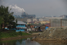 A white column of emissions rises from the nickel processing plant operated by PT Indonesia Weda Bay Industrial Park (IWIP) on Feb. 20, 2025, beyond the riverside village of Lelief in Central Weda district, Central Halmahera regency, North Maluku.