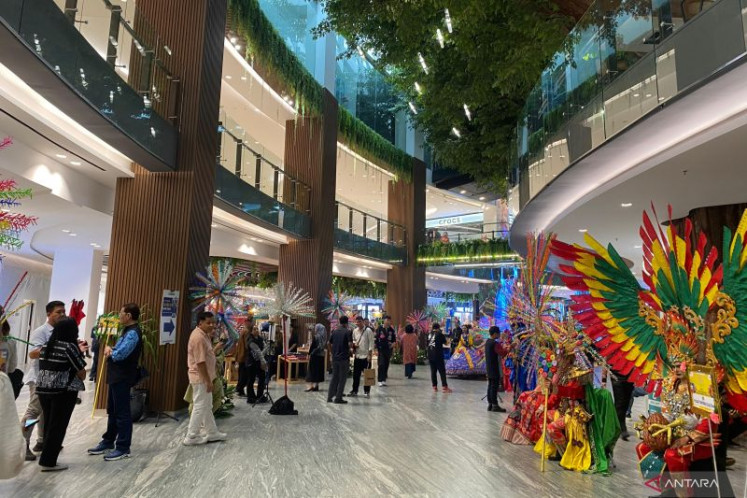 People mill around on June 10, 2025, in a decorated concourse of a shopping mall in Semanggi, South Jakarta.