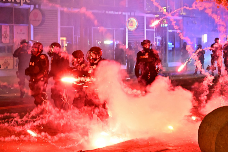 Fireworks explode around police officers in riot gear on Monday during a protest in response to federal immigration operations in the Little Tokyo neighborhood of downtown Los Angeles, the United States. US President Donald Trump's administration said on Monday that it was sending 700 US Marines and thousands more National Guard troops to Los Angeles, sparking a furious response from California's governor over the “deranged“ deployment. Protests in Los Angeles, home to a large Latino population, broke out on June 6, triggered by immigration raids that resulted in dozens of arrests of what authorities say are illegal migrants and gang members. 