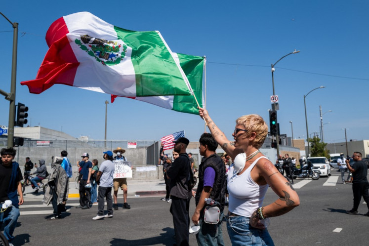 Protesters gather during continuing protests outside of a federal building following raids by Immigration and Customs Enforcement (ICE) that began last Friday, on June 10, 2025 in Los Angeles, California. 
