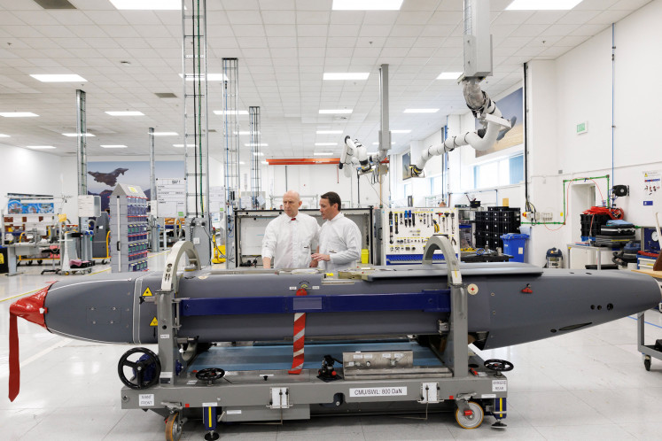 Director of Mechanical Engineering Matt Beaumont shows Defense Secretary John Healey a storm shadow missile on an assembly line at the MBDA Storm Shadow factory on May 31, 2025 in Stevenage, England.