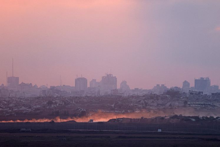 A picture taken from a position on Israel's border with the Gaza Strip shows Israeli military vehicles driving inside the besieged Palestinian territory on June 10.