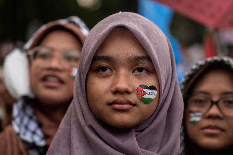 Demonstrator wearing Palestine stickers protest during a pro-Palestine rally in front of the United States embassy in Jakarta on Oct. 25, 2024.