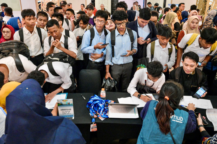 Job seekers register on May 22, 2025, at a job fair attended by over a hundred recruiting companies and thousands of job seekers in Jakarta.