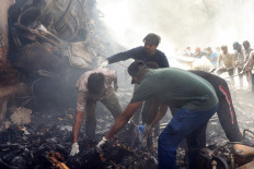 Rescue officials work at the site where Air India flight 171 crashed in a residential area near the airport in Ahmedabad on June 12, 2025. The London-bound passenger plane crashed on June 12 in India's western city of Ahmedabad with 242 on board, aviation officials said in what the airline called a “tragic accident“. 