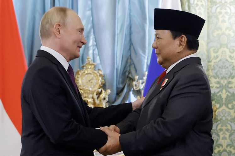 Russian President Vladimir Putin (left) shakes hands with then Indonesian president-elect Prabowo Subianto on July 31, 2024, during a meeting at the Kremlin in Moscow, Russia. Prabowo will meet Putin on June 18 on his first visit to Russia since taking office, the Foreign Ministry said on June 12, as Southeast Asia's biggest economy seeks to boost ties with Moscow.