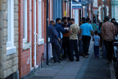 Members of local community stand outside family home of Ramesh Viswashkumar, a British survivor of the London-bound Air India aircraft crash near Ahmedabad Airport in India, in Leicester, Britain, June 12, 2025. 