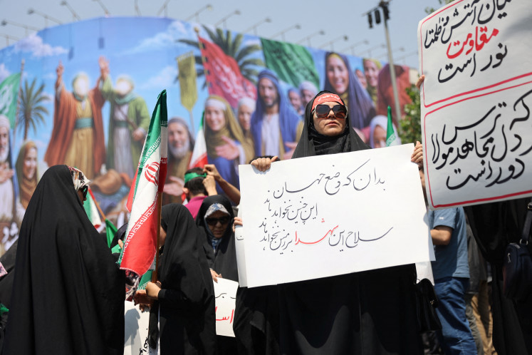 People attend an anti-Israel protest following the Israeli strikes on Iran, in Tehran, June 13. 