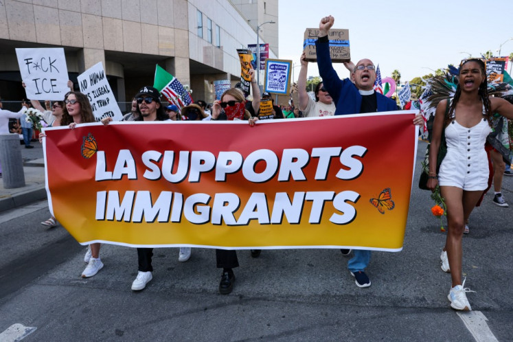 Protesters demonstrate outside of a federal building and Immigration and Customs Enforcement (ICE) detention center on June 13, 2025, in Los Angeles, California, the United States. Demonstrations continue after a series of immigration raids began on June 6. Tensions in the city remain high after the US President Donald Trump's administration called in the National Guard and the Marines against the wishes of city leaders.