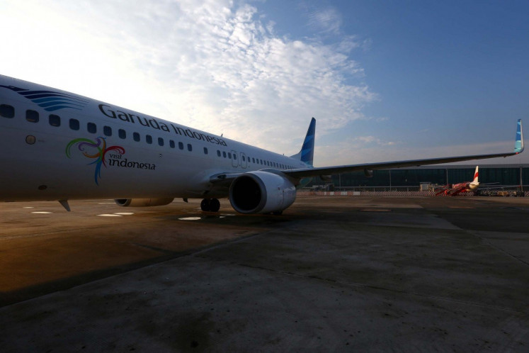 A Garuda Indonesia airplane parks at Terminal 3 of Soekarno-Hatta International Airport in Tangerang, Banten, on June 25. National flag carrier Garuda Indonesia is set to launch chartered flights to five cities in China, starting this month until March. 