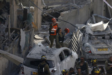 Israeli rescuers search through the rubble at the site of an Iranian missile strike in Bnei Brak on June 16, 2025. Iran unleashed a barrage of missile strikes on Israeli cities early on June 16, after Israel struck military targets deep inside Iran, with both sides threatening further devastation. 