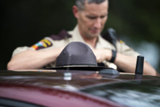 Members of the Minnesota State Patrol block a road as law enforcement search the area around a vehicle on 301st Avenue on June 15, 2025 in Belle Plaine, Minnesota, US. 