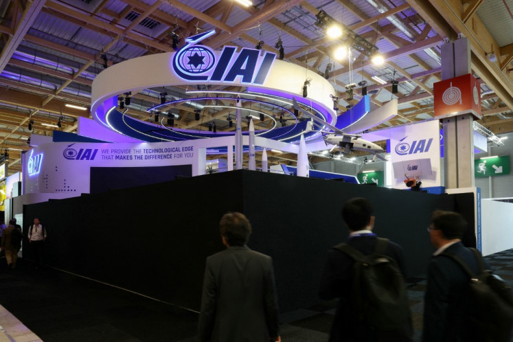Attendees walk past the closed Israel Aerospace Industries (IAI) Israeli Pavillon during the 55th edition of the International Paris Air Show at the Paris–Le Bourget Airport, in Le Bourget, suburb of Paris on June 16, 2025. France on June 16, 2025, blocked access to the stands of five Israeli arms manufacturers at the Paris Air show for displaying “offensive weapons“, according to a French government source. The stands were blocked off by black tarps for showing “offensive weapons“, including those used in Gaza, which allegedly violated terms made with Israel, said the source. The Israeli government condemned the “scandalous“ decision in a statement, calling it a form of “segregation“ against the Israeli companies.