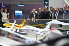 French Prime Minister François Bayrou (center right) visits the stand of French aircraft manufacturer Dassault Aviation with its CEO Eric Trappier (center left) during the 55th edition of the International Paris Air Show at the Paris' Le Bourget Airport, in Le Bourget, suburb of Paris on June 16, 2025. 