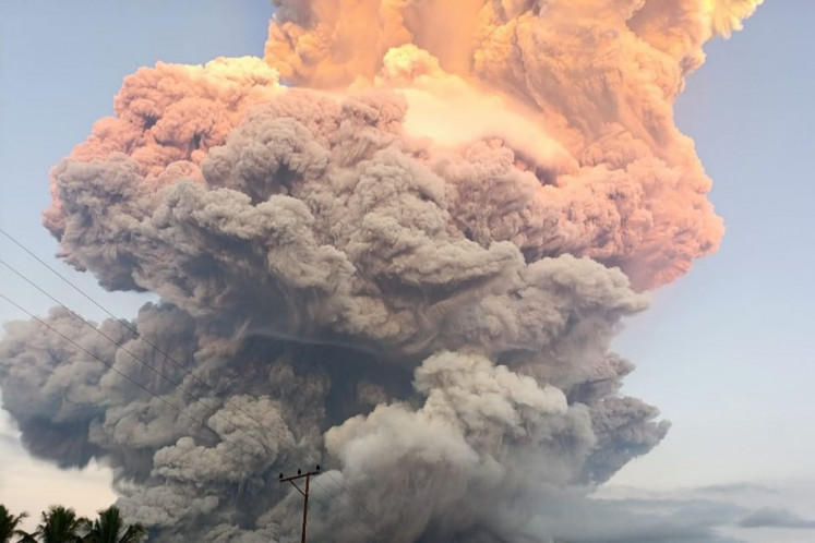 Overwhelming sight: Grayish fumes billow above Mount Lewotobi Laki-laki as it erupts on Tuesday afternoon in East Flores, East Nusa Tenggara.