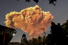 Villagers watch the eruption of Mount Lewotobi Laki-Laki on June 17 as seen from Talibura village in Sikka, East Nusa Tenggara.