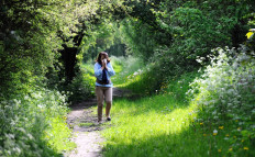 A woman blows her nose in Godewaersvelde, northern France on May 18, 2013, as the return of pleasant weather marks the arrival of allergenic pollen.
