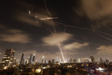 Israeli air defense systems are activated to intercept Iranian missiles over the Israeli city of Tel Aviv early on June 18.