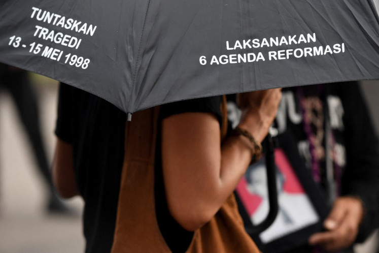 An activist attends a Kamisan (Thursdays) silent protest in front of the Presidential Palace in Jakarta on May 17 , 2018, demanding justice over racially-motivated killings which took place during the fall of former president Suharto in May 1998. 