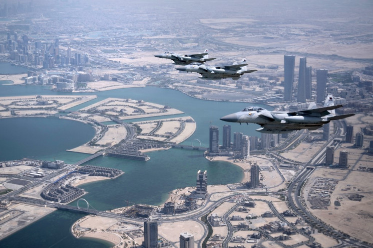 Qatari airforce escorts the plane transporting US President Donald Trump as it prepares to land in Doha from Saudi Arabia on May 14, 2025. Trump touched down at Hamad International Airport in Doha, with relations between the two governments in the spotlight over Qatar's offer to Trump of a $400 million luxury aircraft to serve as a new Air Force One and then pass into his personal use.