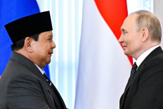 In this pool photograph distributed by the Russian state agency Sputnik, Russia's President Vladimir Putin (right) and President Prabowo Subianto attend signing ceremony after their meeting in Saint Peterburg on June 19, 2025. 