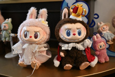 This picture taken on June 18, 2025 shows figures of the characters Mokoko (left) and Labubu in an exhibition room at Pop Marts theme park Pop Land in Beijing. 