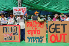 Royalist activists hold signs as they take part in an anti-government protest, following a leak on Wednesday of a phone call between Thailand's Prime Minister Paetongtarn Shinawatra and Cambodia's Hun Sen, the influential former premier of Cambodia, amid a border dispute between the two countries, near the Government House, in Bangkok, Thailand, June 19, 2025.