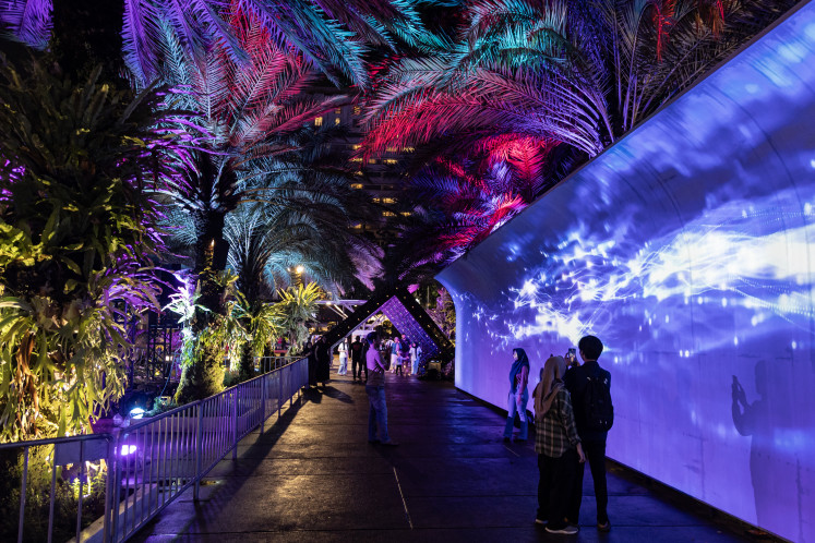 Illuminating Jakarta: Residents observe lighting installations on May 23 at the Jakarta Light Festival 2025 in Lapangan Banteng Park, Jakarta. The festival features various interactive light art installations, video mapping performances on building facades around the park as well as performances by several well-known Indonesian musicians. 