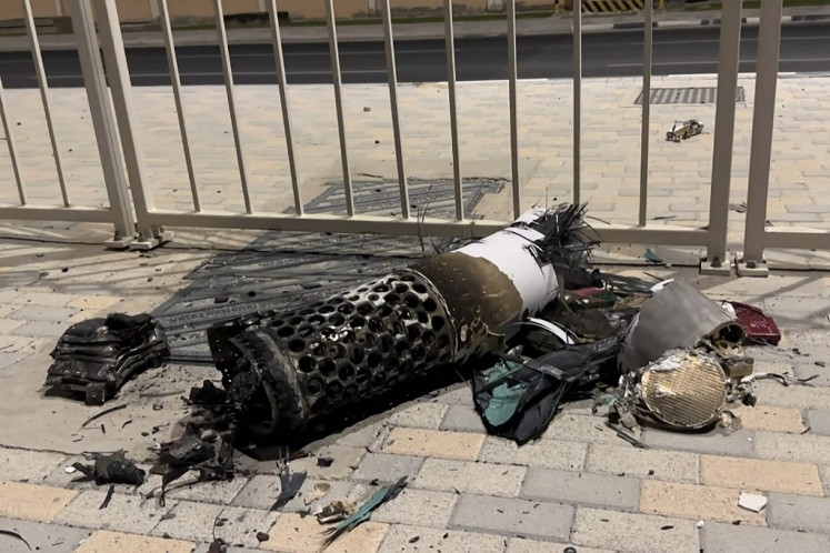 This frame grab take from AFPTV footage shows the remnants of an Iranian missile intercepted over Qatar, as it lies on a pavement near a fence on June 23, 2025. 