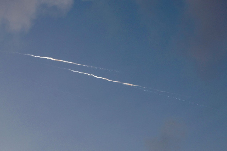 Rocket trails are seen in the sky above the Israeli coastal city of Netanya amid a fresh barrage of Iranian missile attacks on June 24, 2025. 