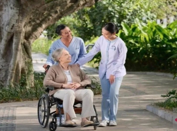 Two health workers attend to a patient on April 29, 2025, at Bali International Hospital in the Sanur Health & Wellness Tourism Special Economic Zone in Denpasar.